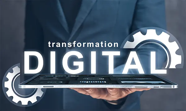 Business mans Holding Tables with the word digital transformation word on top of it for the b2b digital transformation services page